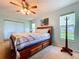Comfortable primary bedroom with a decorative quilt, side tables, and bright windows at 10520 Tapestry Dr, Port Richey, FL 34668