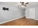 Simple bedroom features ceiling fan, laminate floors, and mounted television at 11200 102Nd Ave # 62, Seminole, FL 33778