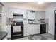 Updated kitchen with stainless steel sink, black appliances, and gray cabinets at 11200 102Nd Ave # 62, Seminole, FL 33778