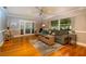 Bright living room featuring hardwood floors, large windows, and access to adjacent rooms at 11200 102Nd Ave # 62, Seminole, FL 33778