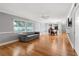 Open living space with hardwood floors, recessed lighting, and a view into the dining area and kitchen at 11200 102Nd Ave # 62, Seminole, FL 33778