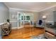 Bright living room featuring hardwood floors, large windows, and access to adjacent rooms at 11200 102Nd Ave # 62, Seminole, FL 33778