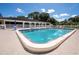 Community swimming pool surrounded by manicured landscape at 11200 102Nd Ave # 62, Seminole, FL 33778
