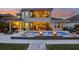 Backyard pool and patio with fire bowls, creating a relaxing outdoor atmosphere at dusk at 11327 Lake Lucaya Dr, Riverview, FL 33579