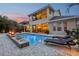 Beautiful pool area with fire bowls, lounge chairs, and view of covered outdoor living space at 11327 Lake Lucaya Dr, Riverview, FL 33579