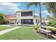 Spacious backyard with lush green lawn, mature landscaping, and a screened lanai at 11327 Lake Lucaya Dr, Riverview, FL 33579