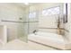 Modern bathroom featuring separate tub and shower with decorative tile at 11327 Lake Lucaya Dr, Riverview, FL 33579