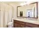 Bright bathroom featuring a double sink vanity with granite countertop and a large mirror at 11327 Lake Lucaya Dr, Riverview, FL 33579