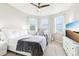 Bright bedroom with natural light from three windows, modern white furniture, and plush carpeting at 11327 Lake Lucaya Dr, Riverview, FL 33579