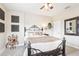 Comfortable bedroom with an iron bed frame, beige-colored bedding, carpet, and a ceiling fan at 11327 Lake Lucaya Dr, Riverview, FL 33579