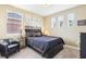 Serene bedroom featuring a dark-colored bed, side tables with lamps, and natural light from windows at 11327 Lake Lucaya Dr, Riverview, FL 33579