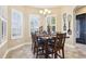 Dining room featuring wainscotting, plantation shutters and elegant lighting at 11327 Lake Lucaya Dr, Riverview, FL 33579