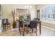 Cozy dining area with a dark wood table, black leather chairs, and ample natural light at 11327 Lake Lucaya Dr, Riverview, FL 33579