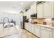 Well-lit kitchen featuring white cabinetry, stainless steel appliances, and a dining area view at 11327 Lake Lucaya Dr, Riverview, FL 33579