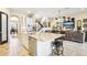 Open-concept kitchen with a large island, stainless steel appliances, and views of the living area at 11327 Lake Lucaya Dr, Riverview, FL 33579