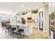Open kitchen area with a large island, white cabinets, and adjacent dining space at 11327 Lake Lucaya Dr, Riverview, FL 33579