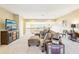 Spacious living room with plush seating, tv, and large windows offering plenty of natural light at 11327 Lake Lucaya Dr, Riverview, FL 33579