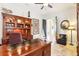 Home office with built-in bookcase and dark wood desk at 11327 Lake Lucaya Dr, Riverview, FL 33579