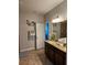 Bathroom showcasing a double sink vanity, granite countertops, and neutral decor at 11617 Brighton Knoll Loop, Riverview, FL 33579