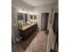 Upstairs bathroom highlighting double sinks with granite countertops, and well-lit mirrors at 11617 Brighton Knoll Loop, Riverview, FL 33579