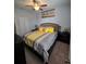 Cozy bedroom featuring a queen-size bed with yellow accents, complemented by dark wood furniture and soft carpeting at 11617 Brighton Knoll Loop, Riverview, FL 33579