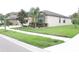 Well-maintained lawn and landscaping surround the home on a corner lot at 11617 Brighton Knoll Loop, Riverview, FL 33579