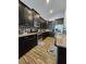 Modern kitchen with stainless steel appliances, granite countertops, and dark cabinetry at 11617 Brighton Knoll Loop, Riverview, FL 33579