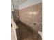Modern bathroom shower featuring tile walls, glass enclosure, and updated fixtures at 11617 Brighton Knoll Loop, Riverview, FL 33579