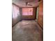Bedroom with paneled walls, ceiling fan and window offering a cozy, customizable space at 1204 W Alsobrook St, Plant City, FL 33563