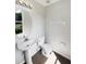 Well-lit bathroom features a pedestal sink, and modern fixtures, creating a comfortable and functional space at 1237 Blenheim Ct, Wesley Chapel, FL 33543