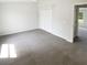 Well-lit bedroom with plush carpeting, closet, and ample space, ideal for relaxation and personalization at 1237 Blenheim Ct, Wesley Chapel, FL 33543