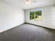Bright bedroom with carpet, neutral walls, and a large window with views to the outdoors at 1237 Blenheim Ct, Wesley Chapel, FL 33543