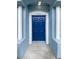 Inviting front entry with covered porch and stylish blue front door featuring white columns at 1237 Blenheim Ct, Wesley Chapel, FL 33543