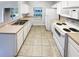 Bright kitchen featuring white appliances, ample counter space, and easy access to outdoor spaces at 1237 Blenheim Ct, Wesley Chapel, FL 33543