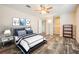 Bedroom featuring a ceiling fan, wood floors, closet, and a queen-sized bed with blue and white bedding at 13039 Keel Ct, Hudson, FL 34667