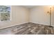 Simple bedroom with wood floors, a window with natural light, and beige walls at 13039 Keel Ct, Hudson, FL 34667
