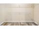 Walk-in closet features wire shelving, offering optimal storage with plank floors and light walls at 13039 Keel Ct, Hudson, FL 34667