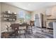 Bright dining room with modern decor, stainless steel fridge, table, and wood-look floors at 13039 Keel Ct, Hudson, FL 34667