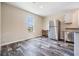 Bright dining area with modern finishes, stainless steel refrigerator, wood-look floors, and natural light at 13039 Keel Ct, Hudson, FL 34667