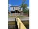 Waterfront home with elevated design and a dock leading to the water's edge at 13039 Keel Ct, Hudson, FL 34667