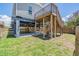 Home exterior featuring a backyard, deck with stairs, and beams supporting the house at 13039 Keel Ct, Hudson, FL 34667