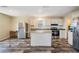 The kitchen features white cabinets, stainless steel appliances, and a center island at 13039 Keel Ct, Hudson, FL 34667