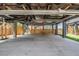 View under elevated house, showing concrete foundation, steel beams, and enclosed, gated area at 13039 Keel Ct, Hudson, FL 34667