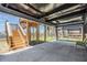 Open space beneath elevated home featuring new wooden staircase and a grassy area leading to the canal at 13039 Keel Ct, Hudson, FL 34667