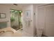 Bright bathroom featuring a glassless window with a view to a private enclosed garden and ample storage at 13878 Oak Forest N Blvd, Seminole, FL 33776
