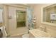 Cozy bathroom features a bathtub with shower, a pedestal sink, and a neutral color scheme at 13878 Oak Forest N Blvd, Seminole, FL 33776