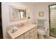 Well-lit bathroom features a neutral color scheme, large vanity, and an adjacent view to a private garden at 13878 Oak Forest N Blvd, Seminole, FL 33776