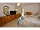 Comfortable bedroom boasts tile floors, a ceiling fan, and a wall of built-in cabinets for extra storage at 13878 Oak Forest N Blvd, Seminole, FL 33776