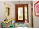 Entryway with a decorative wooden door, tiled floors, and a playful, colorful aesthetic at 13878 Oak Forest N Blvd, Seminole, FL 33776