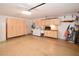 Clean garage with built-in storage cabinets, laundry area, and a large epoxy floor at 13878 Oak Forest N Blvd, Seminole, FL 33776
